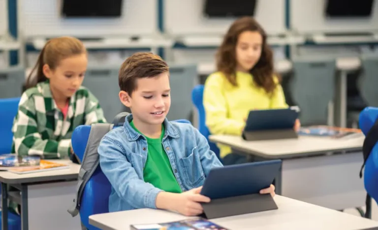 A boy works on a tablet during a coding class at school