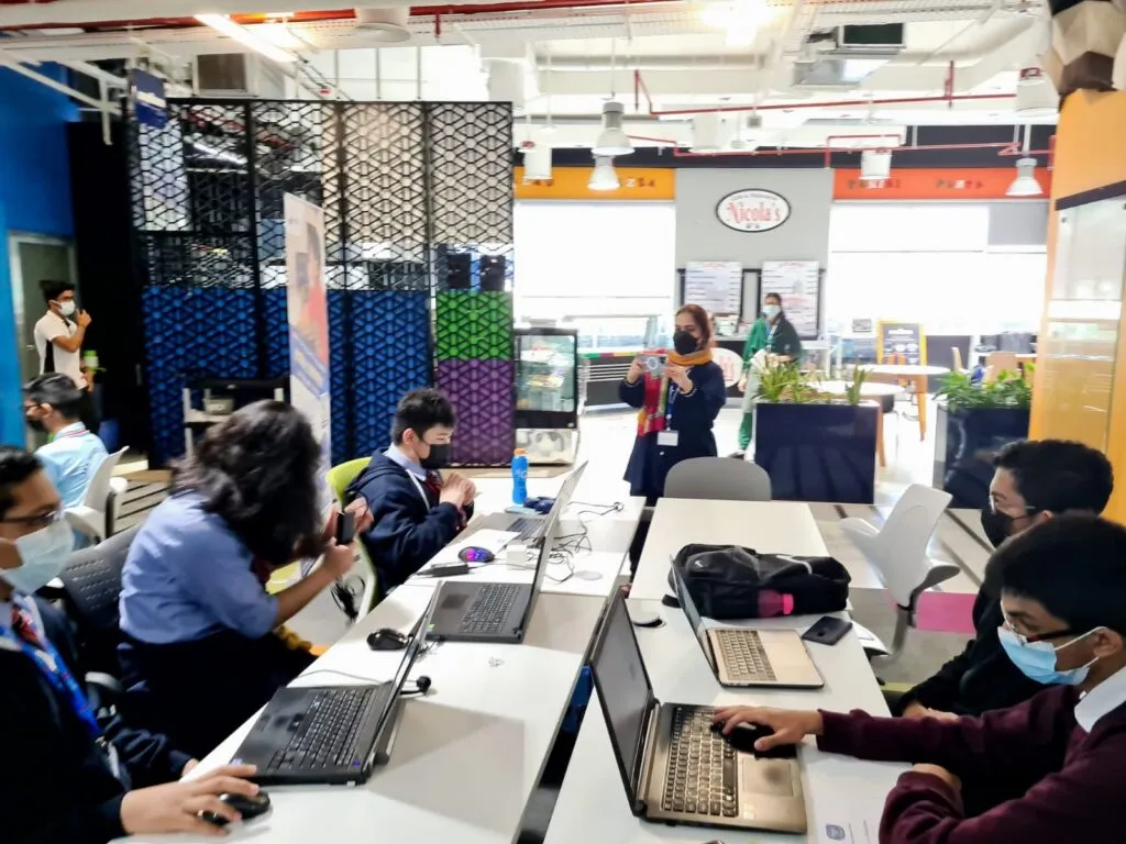 School teams coding on laptops at the first Code Battle, iCodejr's inter-school coding competition at Dtec Dubai, February 2022