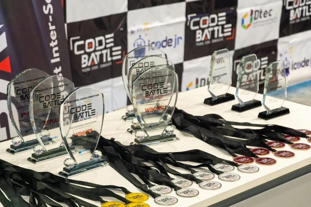 Code Battle trophies and medals lined up for the 2023 UAE national final at DTEC Dubai