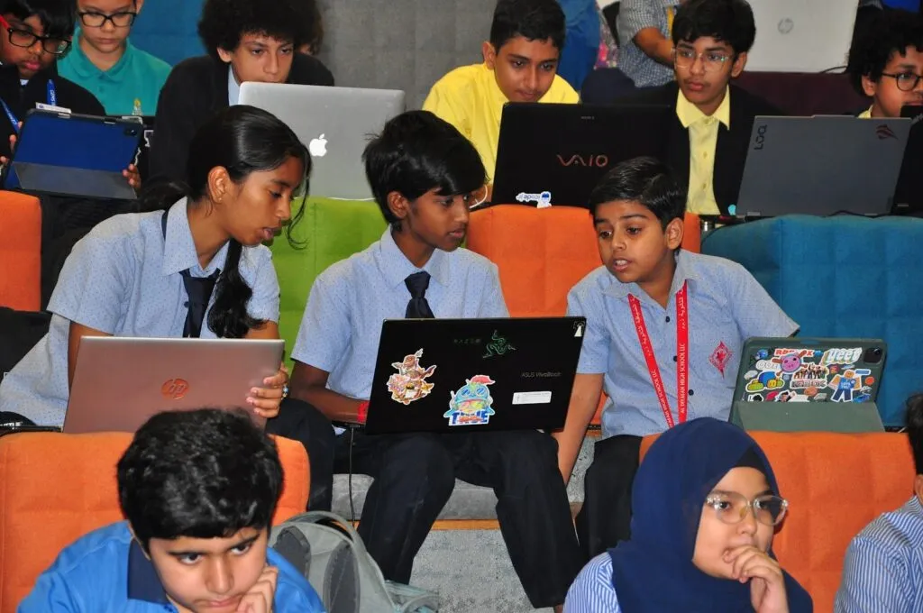 School teams code on laptops during Code Battle 2024 at DTEC Dubai