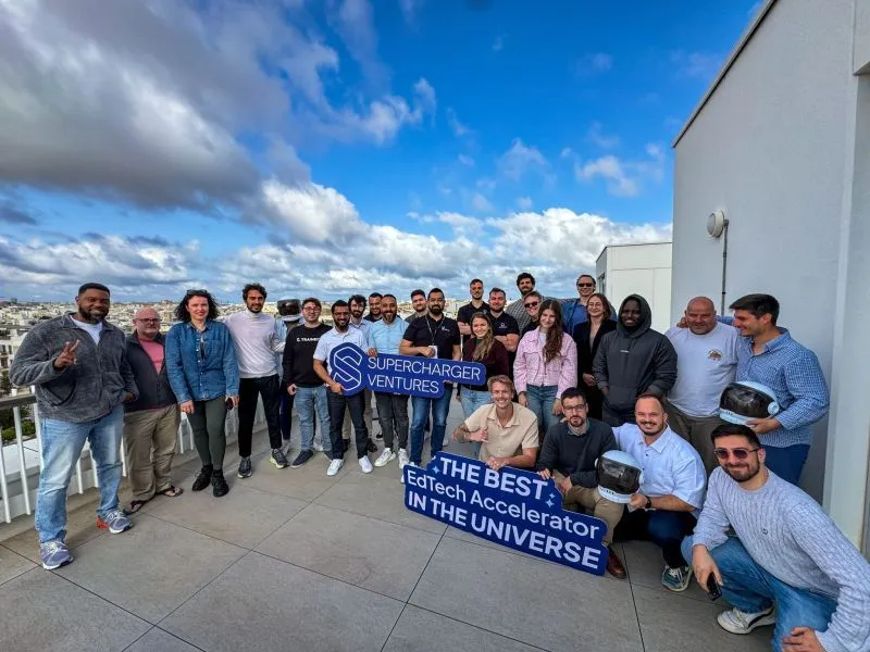 SuperCharger Ventures Cohort 4.0 founders on a rooftop in Malta holding SuperCharger Ventures signs